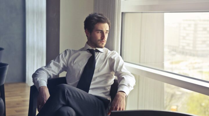 man wearing white dress shirt and black necktie