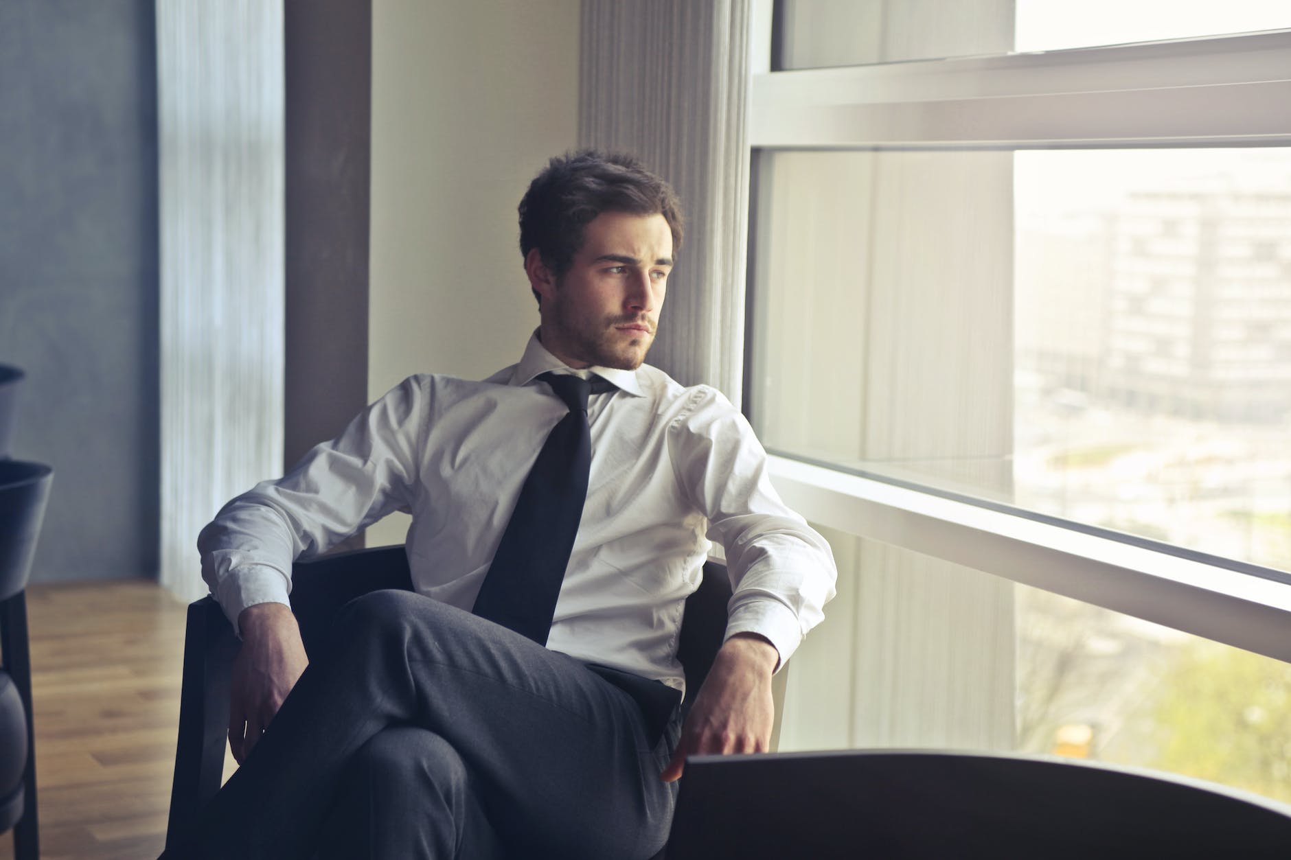 man wearing white dress shirt and black necktie